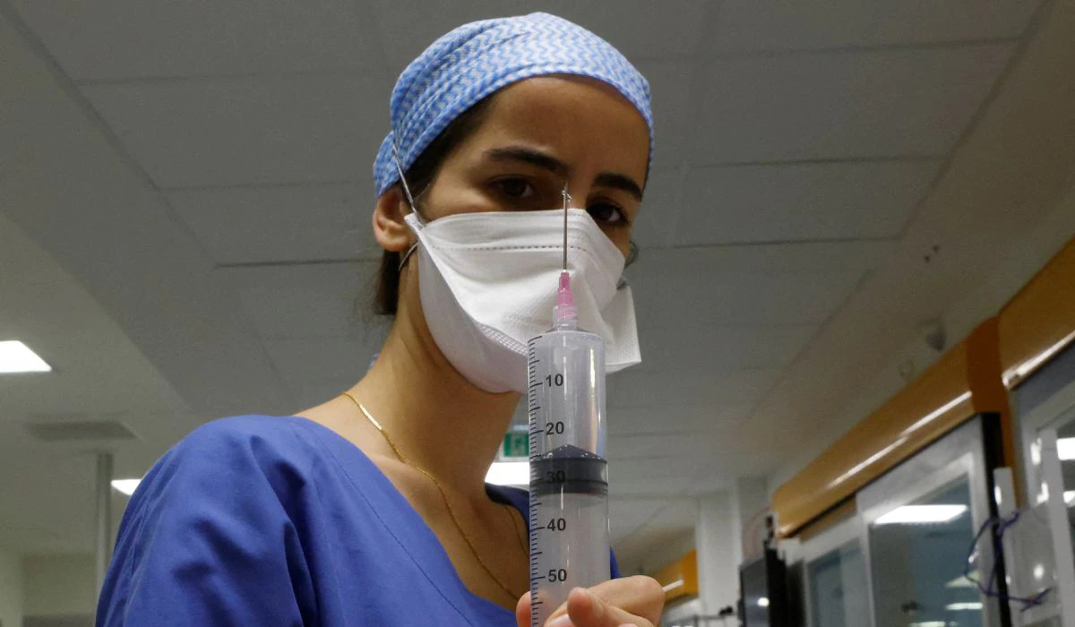 A medical staff member works in the Intensive Care Unit
